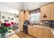 Kitchen with light wood cabinets, tile backsplash, stainless steel appliances, and breakfast area at 374 Cherington Ln, Lawrenceville, GA 30044