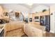 Bright kitchen with stainless steel appliances, light wood cabinets and tiled flooring at 374 Cherington Ln, Lawrenceville, GA 30044