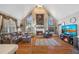 Bright living room with vaulted ceiling, fireplace, large windows, and a comfortable seating area at 374 Cherington Ln, Lawrenceville, GA 30044