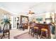 Living area with a home bar, cozy seating, and French doors leading to an outdoor space at 374 Cherington Ln, Lawrenceville, GA 30044