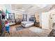 Spacious main bedroom featuring a tray ceiling, wood floors, sitting area, and ample natural light at 374 Cherington Ln, Lawrenceville, GA 30044