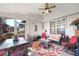 Cozy sunroom with wicker furniture, ceiling fan, and plenty of natural light for relaxing or entertaining at 374 Cherington Ln, Lawrenceville, GA 30044