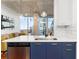 Modern kitchen with white cabinets, navy lower cabinets, and city views at 3324 Peachtree Ne Rd # 1813, Atlanta, GA 30326