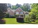 Charming brick home featuring a well-manicured lawn and mature trees at 2883 Thurleston Ln, Duluth, GA 30097