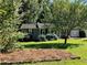 Gray Ranch home with pine straw and lush green grass at 2832 Jordan Forest Nw Trl, Lawrenceville, GA 30044