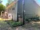 Side view of the house with gray siding and garden at 2832 Jordan Forest Nw Trl, Lawrenceville, GA 30044