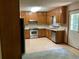 Kitchen with wood cabinets, stainless steel appliances, and back door at 2832 Jordan Forest Nw Trl, Lawrenceville, GA 30044