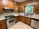 Kitchen with wood cabinets and stainless steel appliances at 2832 Jordan Forest Nw Trl, Lawrenceville, GA 30044