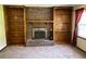 Living room featuring a brick fireplace and wood shelving at 2832 Jordan Forest Nw Trl, Lawrenceville, GA 30044