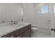 Clean bathroom with bathtub, toilet, vanity, and white subway tile at 2023 Fern Mountain Ln, Marietta, GA 30064