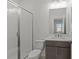 Modern bathroom with shower, toilet, vanity, and stylish gray cabinets at 2023 Fern Mountain Ln, Marietta, GA 30064