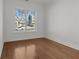 Simple bedroom with hardwood floors and a view at 2023 Fern Mountain Ln, Marietta, GA 30064