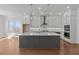 Modern kitchen with white cabinets, large island, and stainless steel appliances at 2023 Fern Mountain Ln, Marietta, GA 30064