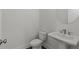 Convenient powder room with pedestal sink and toilet at 2023 Fern Mountain Ln, Marietta, GA 30064