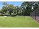 Community tennis court with grassy area and trees at 3135 Seven Pines Ct # 101, Atlanta, GA 30339