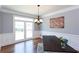 Dining room with hardwood floors, wainscoting, and a chandelier, overlooking backyard at 4083 Brookside Manor Dr, Tucker, GA 30084