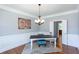 Formal dining room with hardwood floors, wainscoting, and a chandelier at 4083 Brookside Manor Dr, Tucker, GA 30084