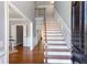 Elegant entryway with hardwood floors and a staircase with a metal railing at 4083 Brookside Manor Dr, Tucker, GA 30084