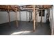 Unfinished basement provides ample storage or potential for customization with visible beams and supports at 3685 Emily Way, Atlanta, GA 30349