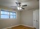 This bedroom features hardwood floors, a ceiling fan, and closet space at 3685 Emily Way, Atlanta, GA 30349