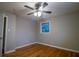 Hardwood floor bedroom with ceiling fan and access to bathroom at 3685 Emily Way, Atlanta, GA 30349