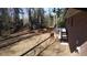 Back exterior of a brick home and wooded backyard on a sunny day at 3685 Emily Way, Atlanta, GA 30349