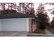 White garage door with black roof at 3685 Emily Way, Atlanta, GA 30349