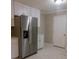 Bright kitchen with stainless steel refrigerator and white cabinetry at 3685 Emily Way, Atlanta, GA 30349