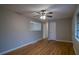 A bright living room featuring hardwood floors, neutral walls, and a ceiling fan for added comfort at 3685 Emily Way, Atlanta, GA 30349