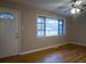 Living room with hardwood floors, large window, and front door at 3685 Emily Way, Atlanta, GA 30349