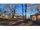 Yard with mature trees and a view of the back of the house at 557 Mccullough Rd, Stockbridge, GA 30281