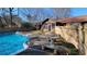 Inviting backyard with a swimming pool, patio furniture, and wooden fence at 557 Mccullough Rd, Stockbridge, GA 30281