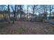 Large backyard with mature trees and a partially visible fence at 557 Mccullough Rd, Stockbridge, GA 30281