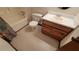 Bathroom with tub, toilet and wood vanity at 557 Mccullough Rd, Stockbridge, GA 30281