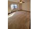 Spacious carpeted bedroom with window and ceiling fan at 557 Mccullough Rd, Stockbridge, GA 30281