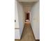 Long hallway with carpeted floor and access to bedrooms at 557 Mccullough Rd, Stockbridge, GA 30281