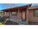 Ranch house with covered porch, brown siding, and green shutters at 557 Mccullough Rd, Stockbridge, GA 30281