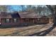 Brown sided ranch home with green shutters and mature trees at 557 Mccullough Rd, Stockbridge, GA 30281