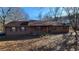 Ranch style home with brown siding, green shutters, and a covered porch at 557 Mccullough Rd, Stockbridge, GA 30281
