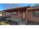 Ranch house with covered porch, brown siding, and green shutters at 557 Mccullough Rd, Stockbridge, GA 30281