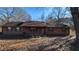 Ranch style home with brown siding, green shutters, and a covered porch at 557 Mccullough Rd, Stockbridge, GA 30281