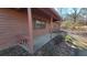 Side view of a ranch house with covered porch and brown siding at 557 Mccullough Rd, Stockbridge, GA 30281