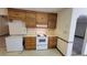 Kitchen with wood cabinets, white appliances, and good counter space at 557 Mccullough Rd, Stockbridge, GA 30281