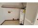Laundry area with water heater and built-in shelving at 557 Mccullough Rd, Stockbridge, GA 30281