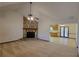 Living room with stone fireplace and access to kitchen and dining area at 557 Mccullough Rd, Stockbridge, GA 30281