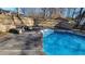 Spacious pool area with a patio and stone table for outdoor relaxation at 557 Mccullough Rd, Stockbridge, GA 30281