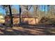 Wooden storage shed with stone base and adjacent woods at 557 Mccullough Rd, Stockbridge, GA 30281