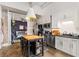 Open-concept kitchen leading to the bedroom, featuring stainless appliances and white cabinets at 978 North Ne Ave # 107, Atlanta, GA 30306