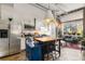 Open concept kitchen with island, stainless steel appliances, and exposed brick at 978 North Ne Ave # 107, Atlanta, GA 30306