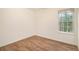 Simple bedroom with wood-look floors and a large window at 261 Quail Run, Roswell, GA 30076